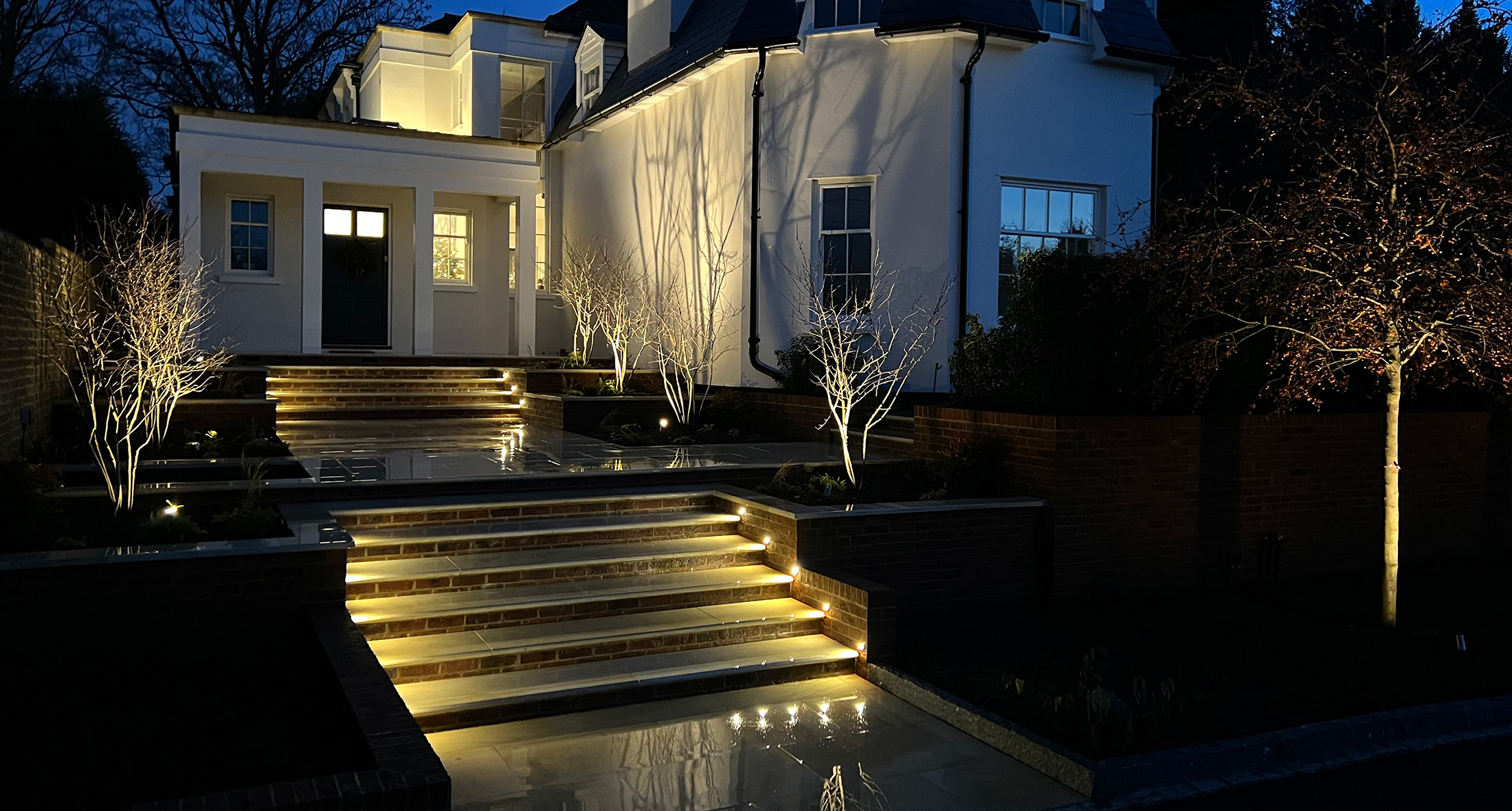 Slate Grey garden lighting downlighters on a wooden clad wall in a newly designed and landscaped garden in Tunbridge Wells, Kent